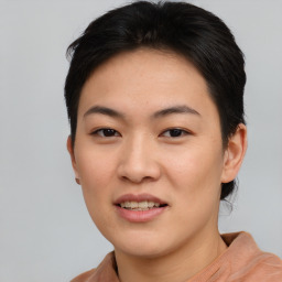 Joyful asian young-adult female with short  black hair and brown eyes