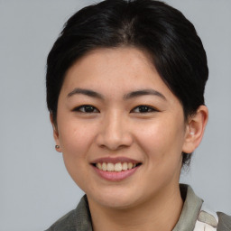 Joyful asian young-adult female with medium  brown hair and brown eyes