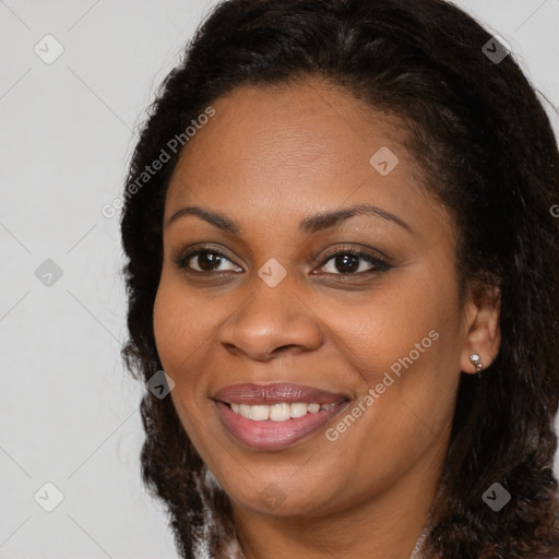 Joyful black young-adult female with medium  brown hair and brown eyes