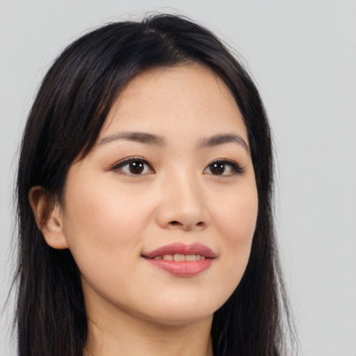 Joyful asian young-adult female with long  brown hair and brown eyes