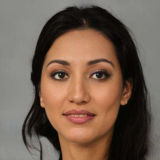 Joyful latino young-adult female with long  black hair and brown eyes