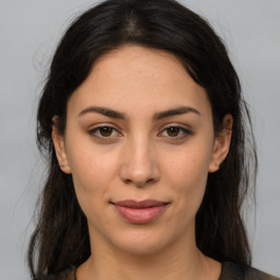 Joyful latino young-adult female with medium  brown hair and brown eyes