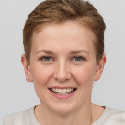 Joyful white young-adult female with short  brown hair and grey eyes