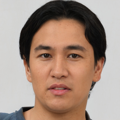 Joyful asian young-adult male with short  black hair and brown eyes