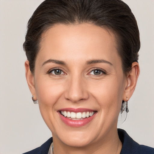 Joyful white young-adult female with medium  brown hair and brown eyes