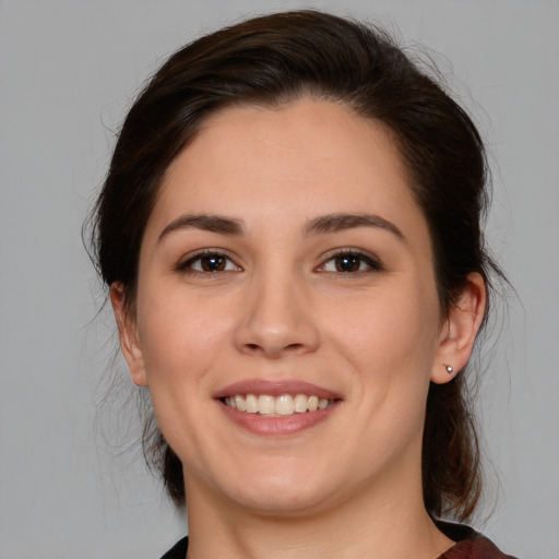 Joyful white young-adult female with medium  brown hair and brown eyes