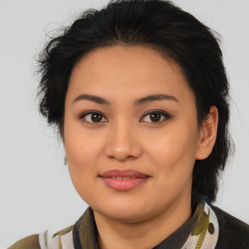 Joyful latino young-adult female with medium  brown hair and brown eyes
