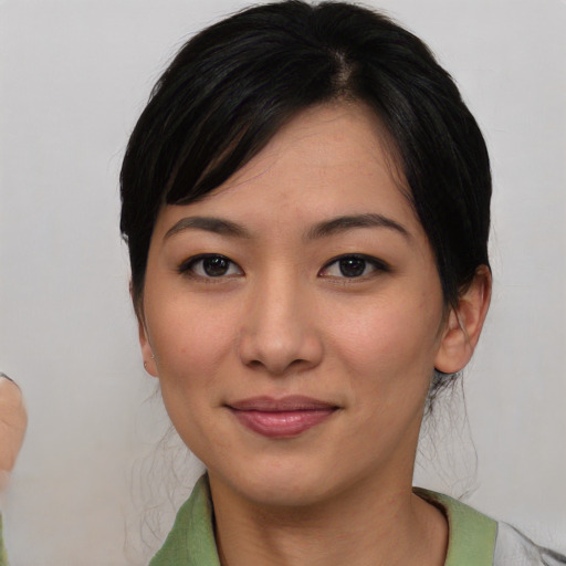 Joyful asian young-adult female with short  black hair and brown eyes