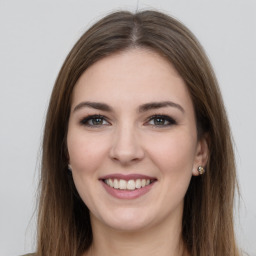 Joyful white young-adult female with long  brown hair and grey eyes