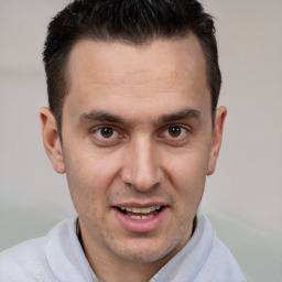 Joyful white adult male with short  brown hair and brown eyes