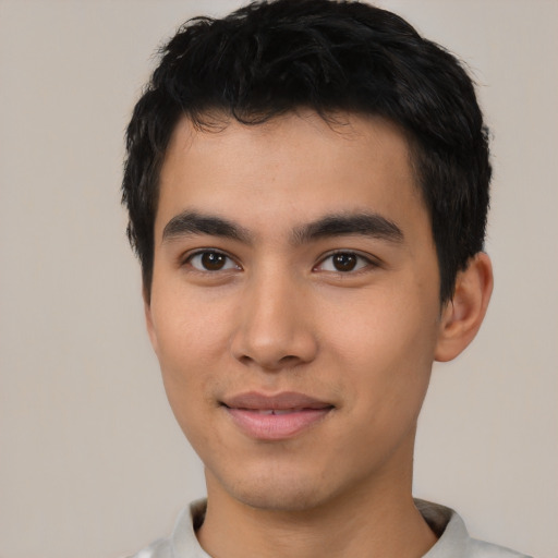 Joyful asian young-adult male with short  black hair and brown eyes