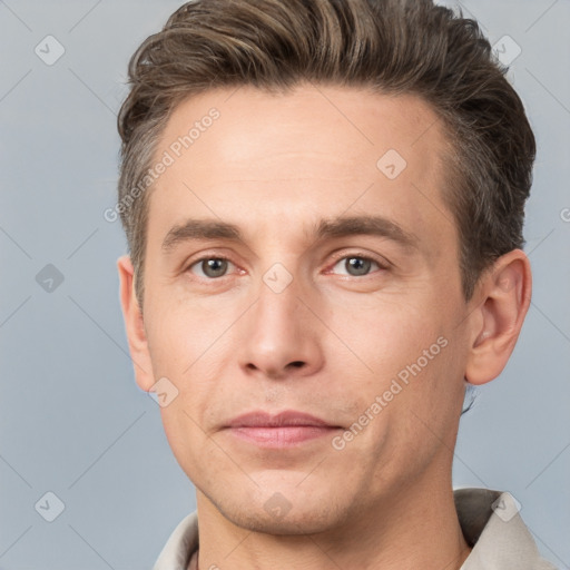 Joyful white adult male with short  brown hair and grey eyes