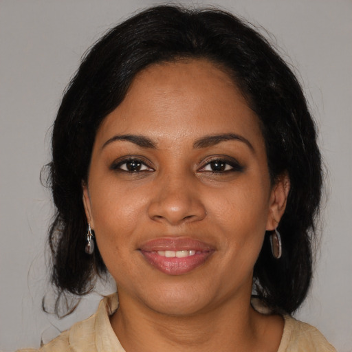 Joyful black young-adult female with medium  brown hair and brown eyes