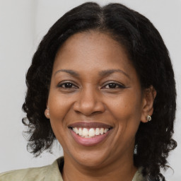 Joyful black adult female with medium  brown hair and brown eyes