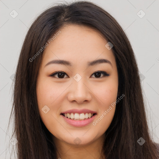 Joyful asian young-adult female with long  brown hair and brown eyes