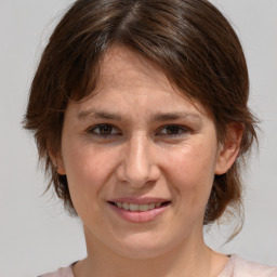 Joyful white adult female with medium  brown hair and brown eyes