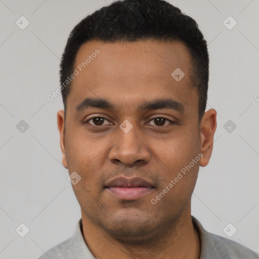 Joyful latino young-adult male with short  black hair and brown eyes