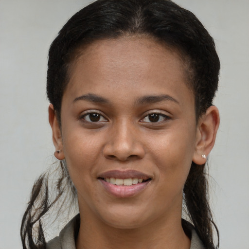 Joyful black young-adult female with short  brown hair and brown eyes