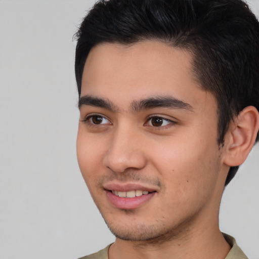 Joyful asian young-adult male with short  brown hair and brown eyes