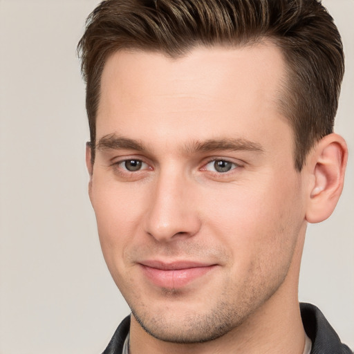 Joyful white young-adult male with short  brown hair and brown eyes