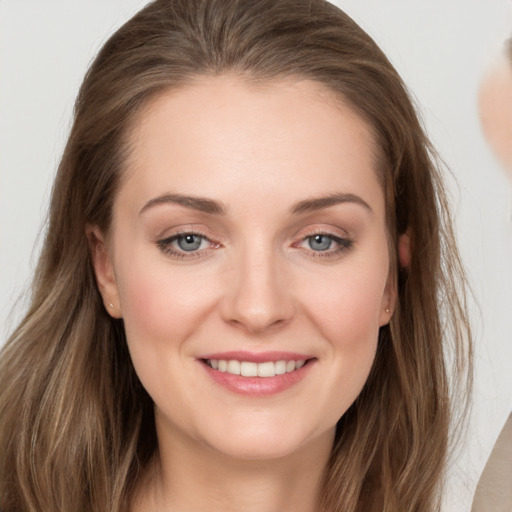 Joyful white young-adult female with long  brown hair and grey eyes