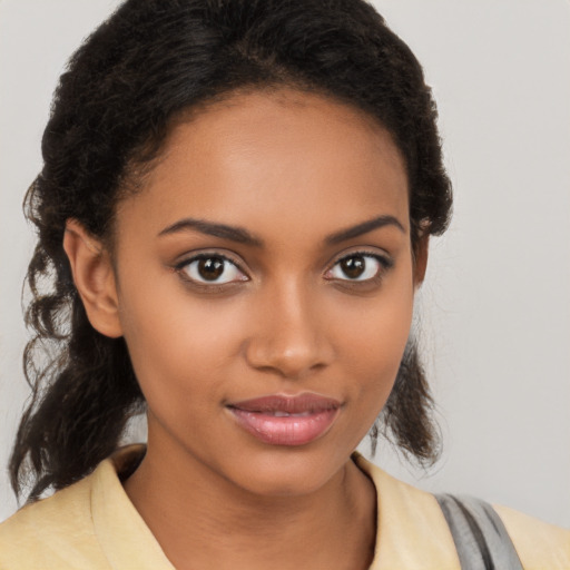 Joyful black young-adult female with medium  brown hair and brown eyes