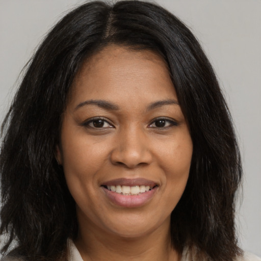 Joyful black young-adult female with medium  brown hair and brown eyes