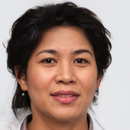Joyful asian adult female with medium  brown hair and brown eyes
