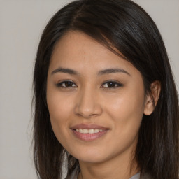 Joyful asian young-adult female with long  brown hair and brown eyes