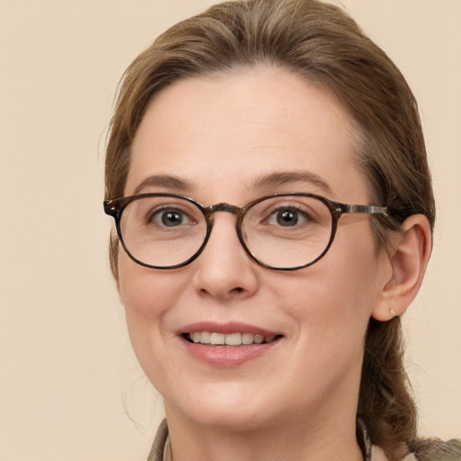 Joyful white adult female with long  brown hair and brown eyes