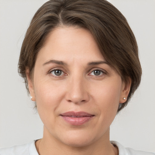 Joyful white adult female with medium  brown hair and brown eyes