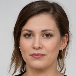 Joyful white young-adult female with medium  brown hair and grey eyes