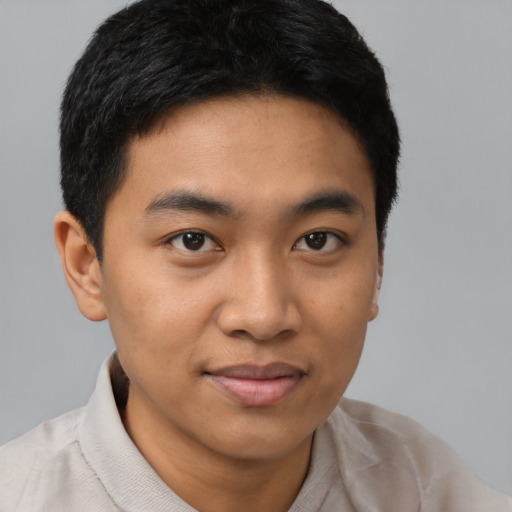 Joyful latino young-adult male with short  brown hair and brown eyes