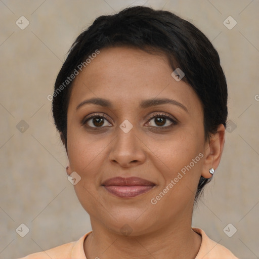 Joyful latino adult female with short  brown hair and brown eyes