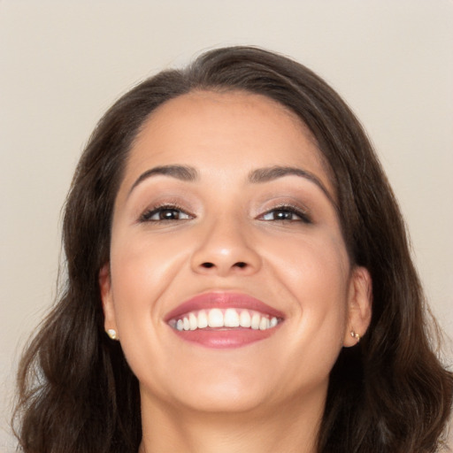 Joyful white young-adult female with long  brown hair and brown eyes