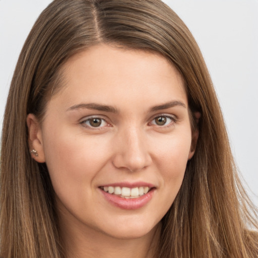 Joyful white young-adult female with long  brown hair and brown eyes