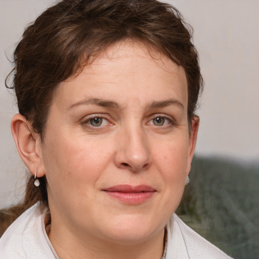 Joyful white adult female with medium  brown hair and grey eyes