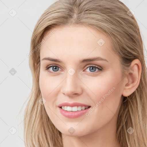 Joyful white young-adult female with long  brown hair and blue eyes