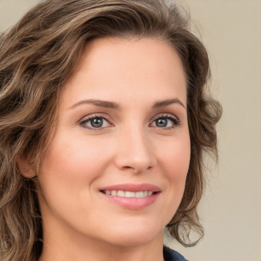 Joyful white young-adult female with medium  brown hair and green eyes