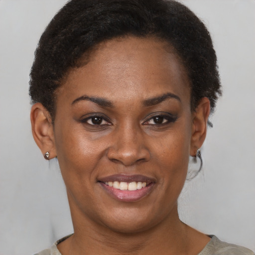 Joyful black young-adult female with short  brown hair and brown eyes