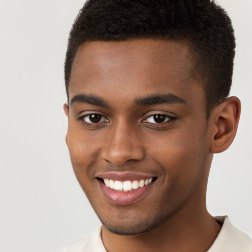 Joyful black young-adult male with short  brown hair and brown eyes