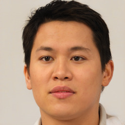 Joyful asian young-adult male with short  brown hair and brown eyes