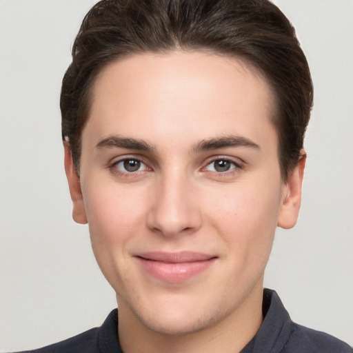 Joyful white young-adult male with short  brown hair and brown eyes