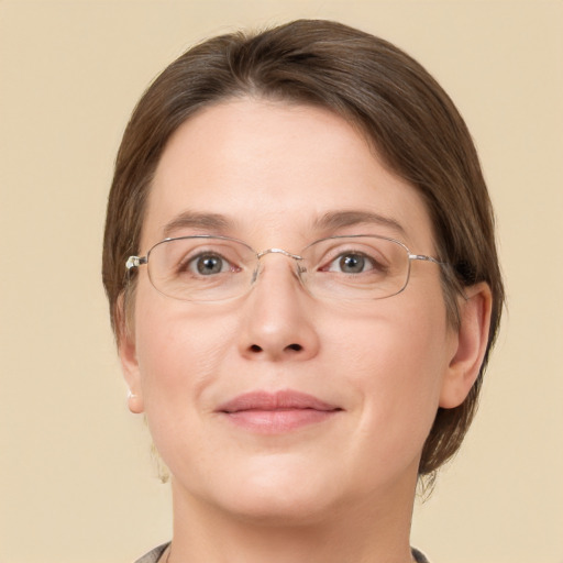 Joyful white adult female with medium  brown hair and grey eyes