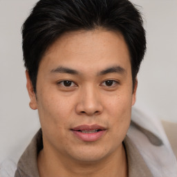 Joyful asian young-adult male with short  brown hair and brown eyes