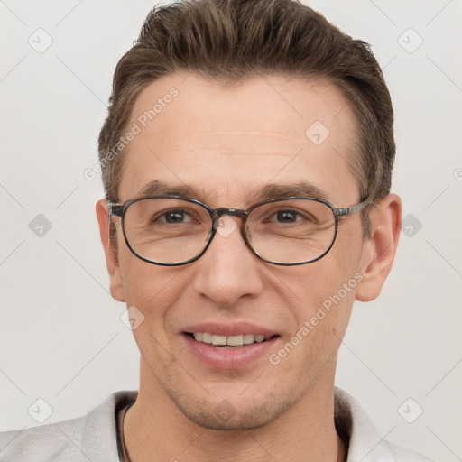 Joyful white adult male with short  brown hair and grey eyes