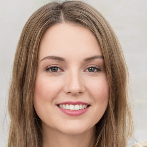 Joyful white young-adult female with long  brown hair and green eyes