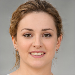 Joyful white young-adult female with medium  brown hair and green eyes