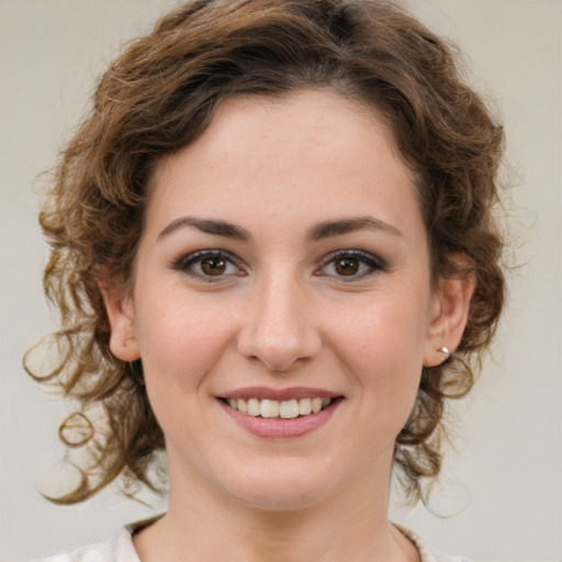 Joyful white young-adult female with medium  brown hair and green eyes