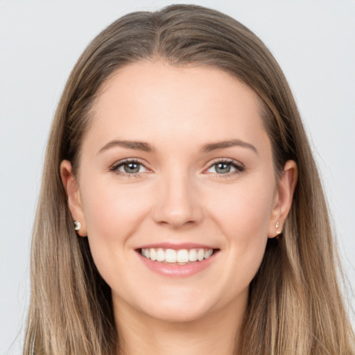 Joyful white young-adult female with long  brown hair and grey eyes